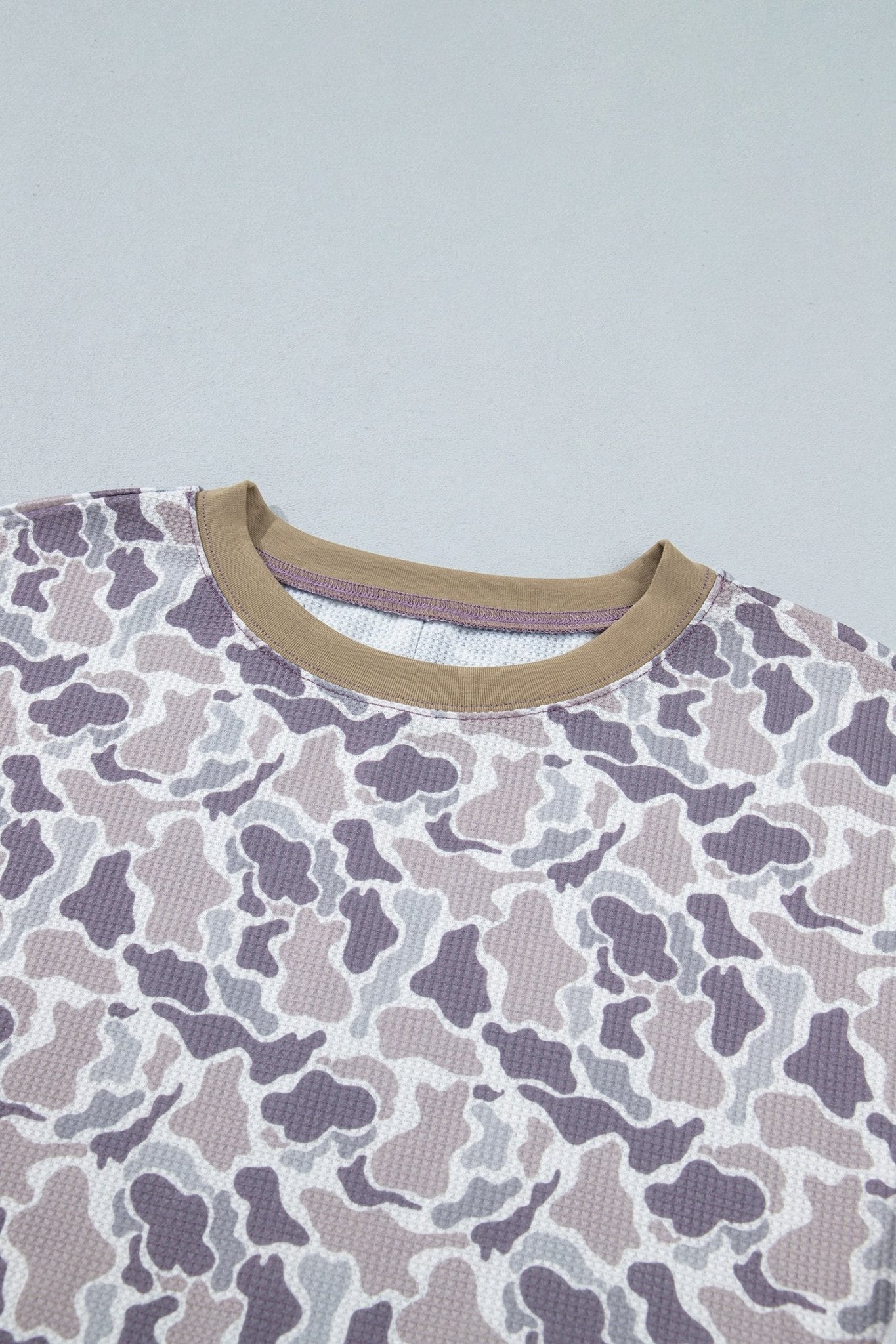Close-up of gray-taupe-purple camo shirt with contrasting tan ribbed collar.