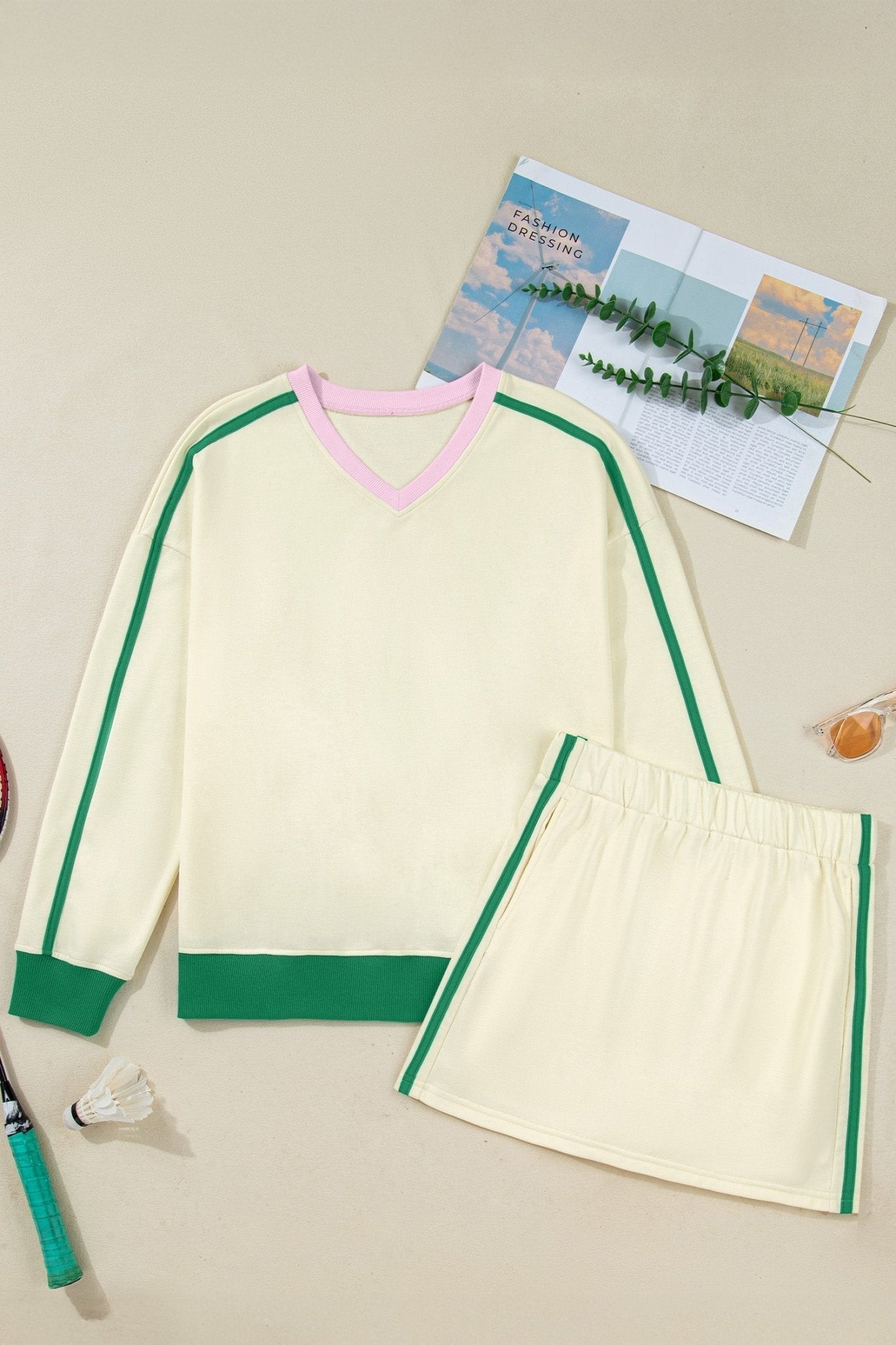 Green and pink sweater with matching skirt on a neutral background