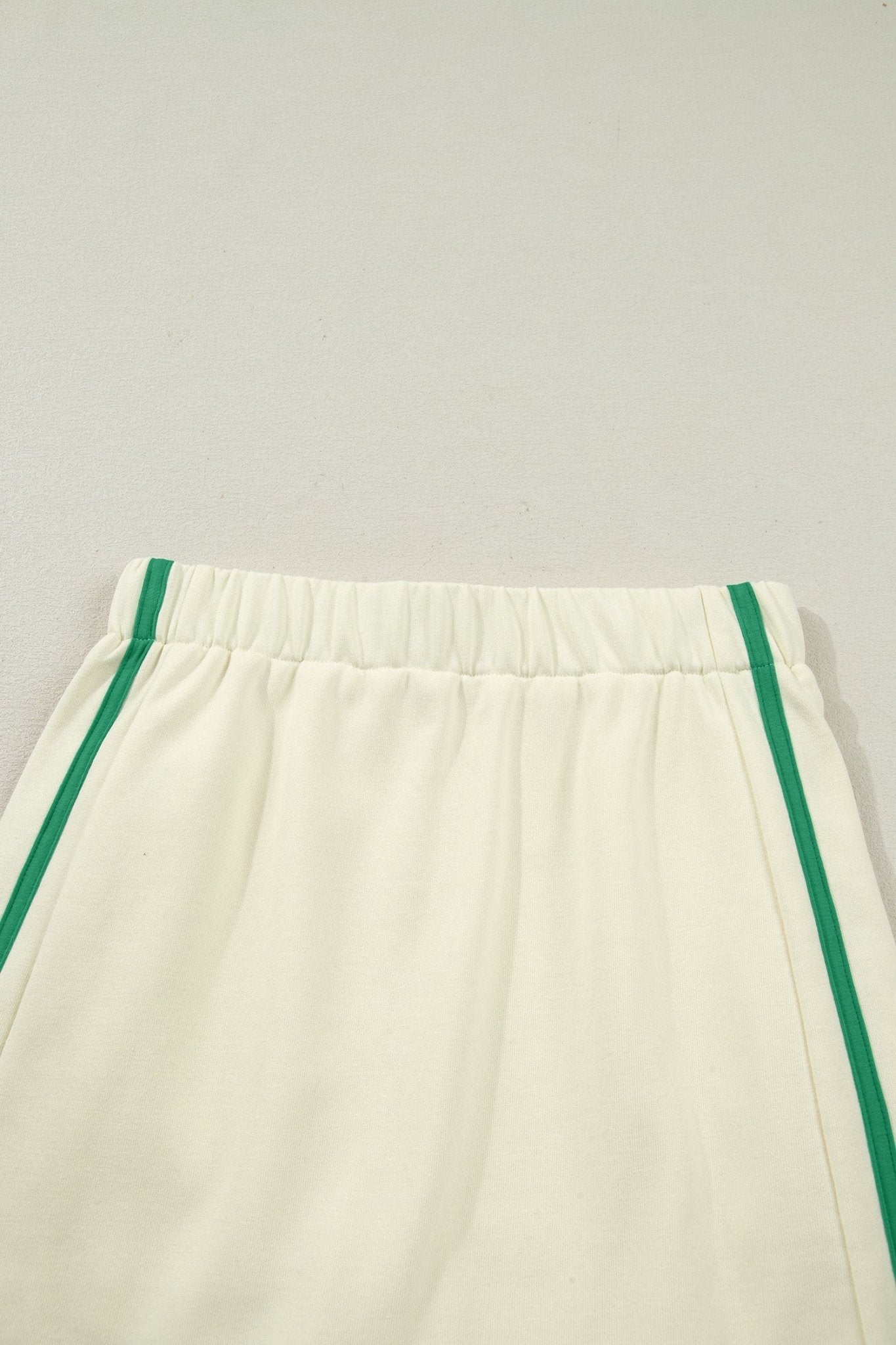 White pants with green trim on a light gray background