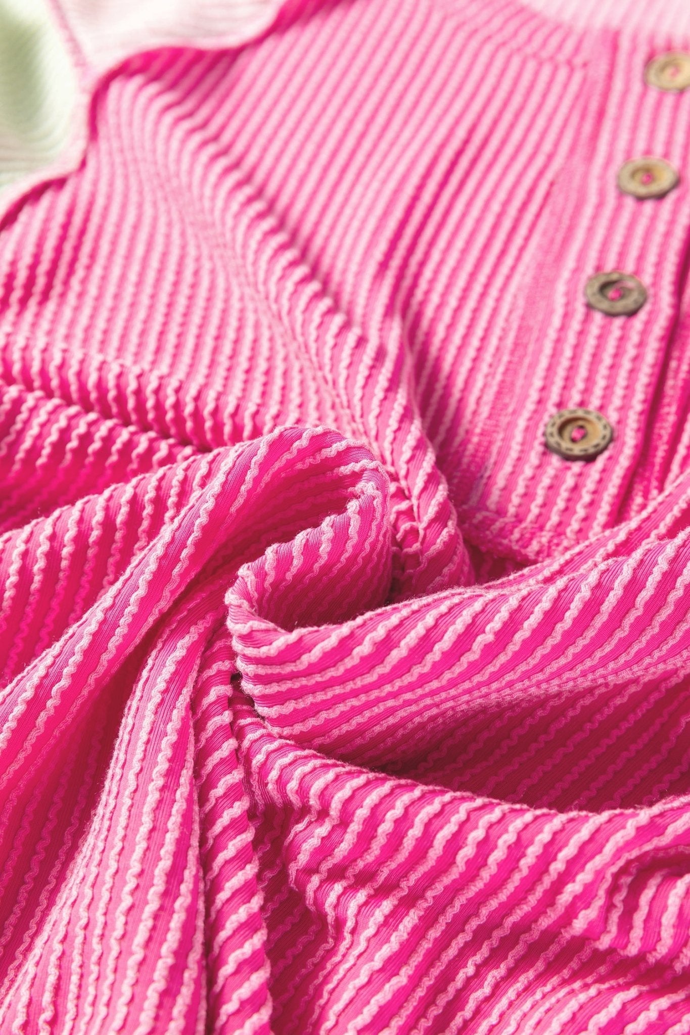 Close-up of pink textured fabric with buttons