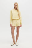 Woman wearing a yellow outfit on a white background