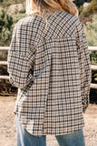 Person wearing a plaid jacket with a natural outdoor background