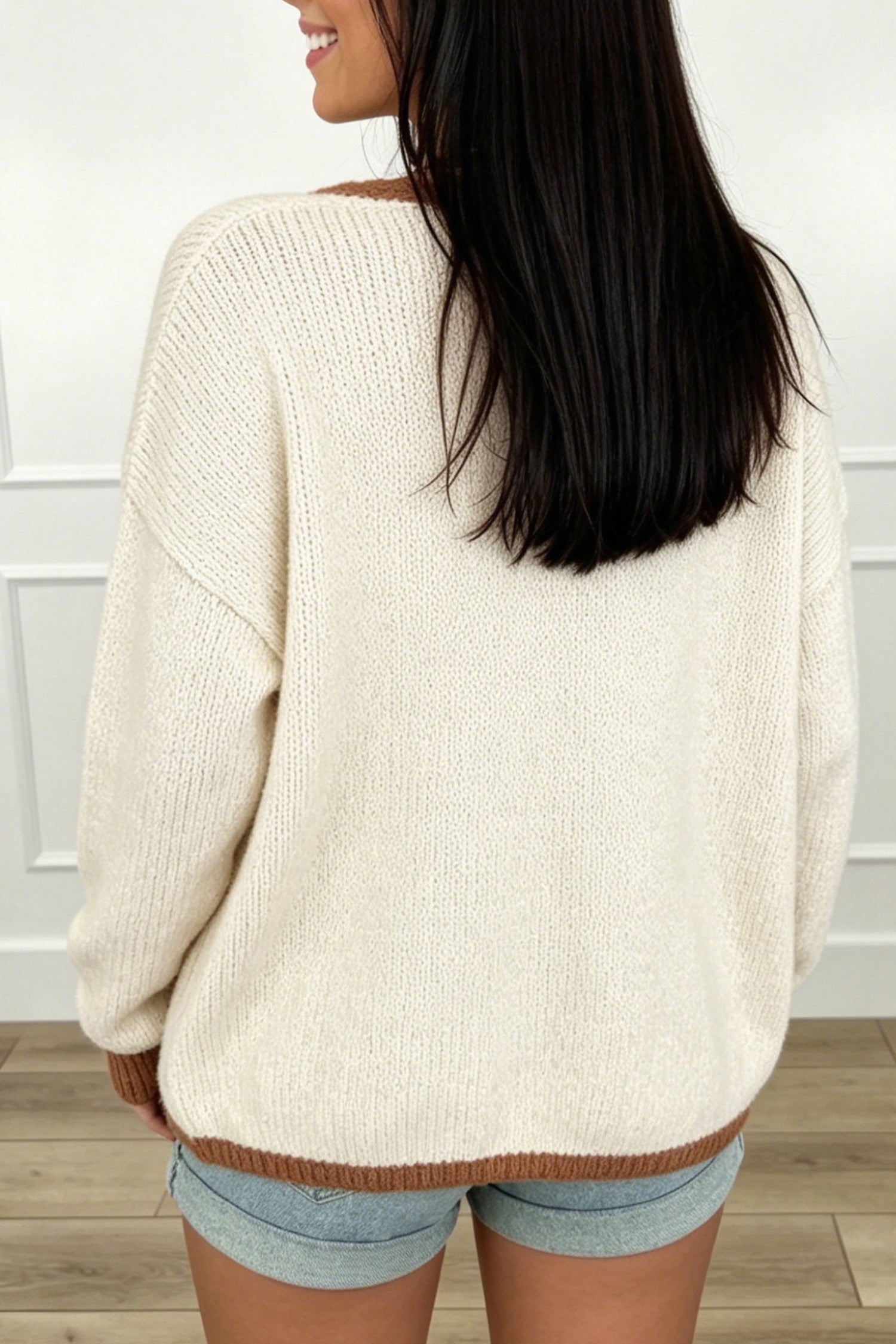 Back view of apricot oversized knit cardigan with chestnut contrast trim