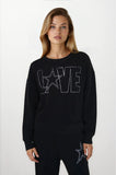 Woman wearing a black sweater with 'LOVE' and star design on a white background