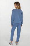 Woman wearing a blue tracksuit on a white background