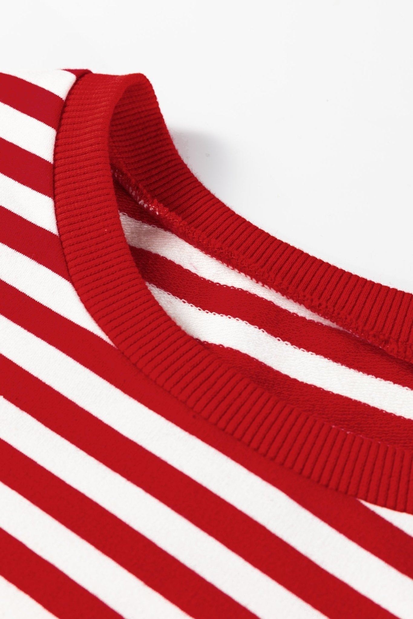 Close-up of a red and white striped garment with a ribbed texture.