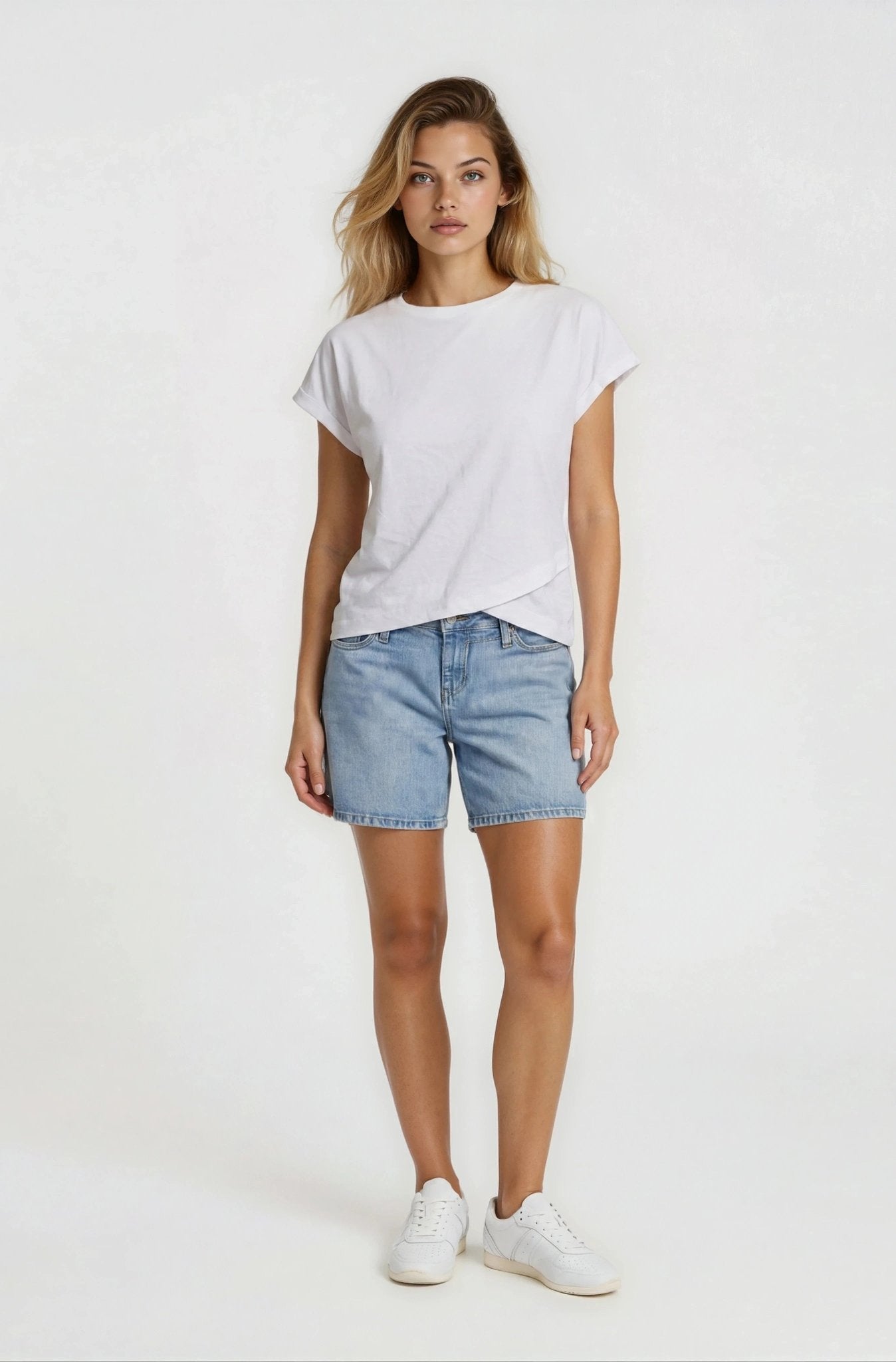 Woman wearing a white t-shirt and denim shorts on a white background