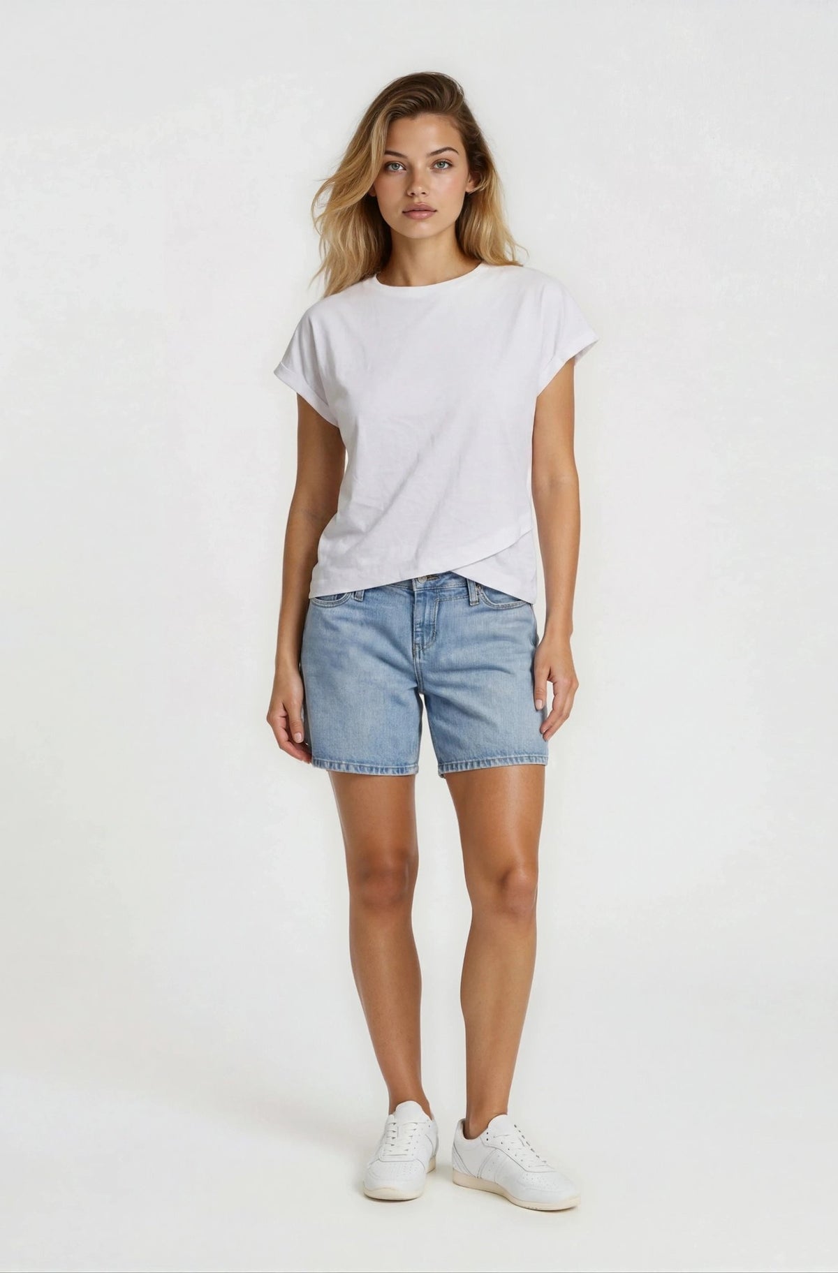 Woman wearing a white t-shirt and denim shorts on a white background