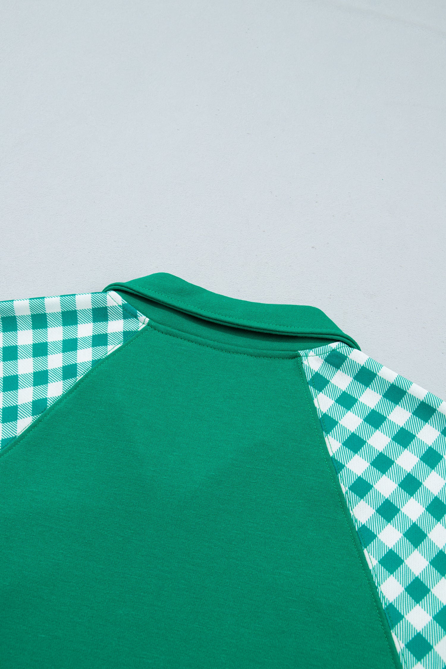Dark green sweatshirt back collar and gingham shoulder detail