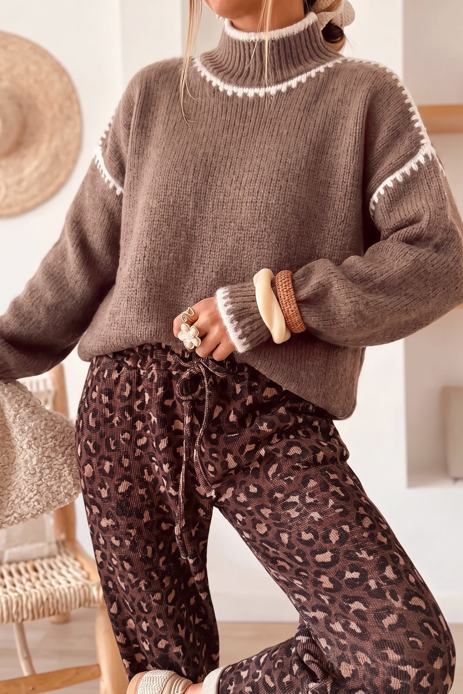 Dark khaki contrast stitch mock neck sweater styled with leopard print pants