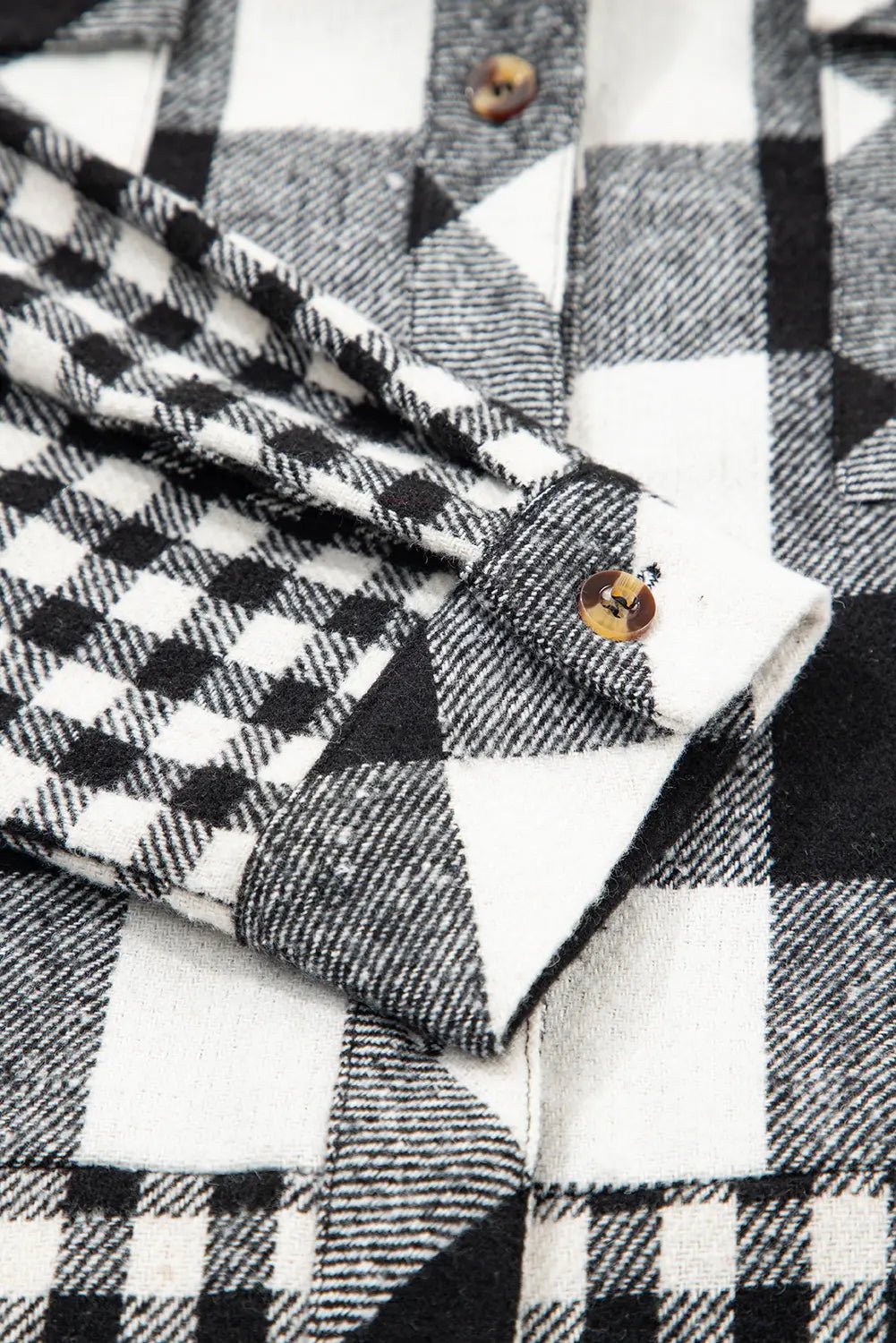 Close-up of a black and white checkered fabric with a button.