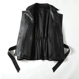 Black leather vest with straps on a white background