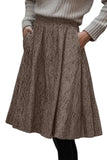 Brown-beige herringbone skirt with side pockets and gray ribbed sweater.