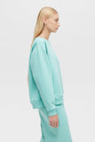 Person wearing a light blue outfit on a white background