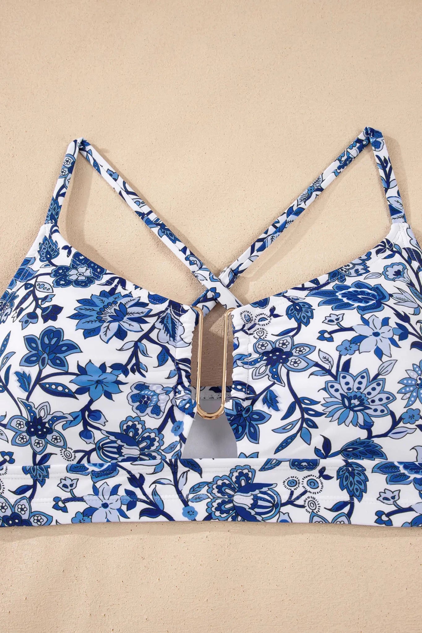 Blue floral-patterned top on a beige background