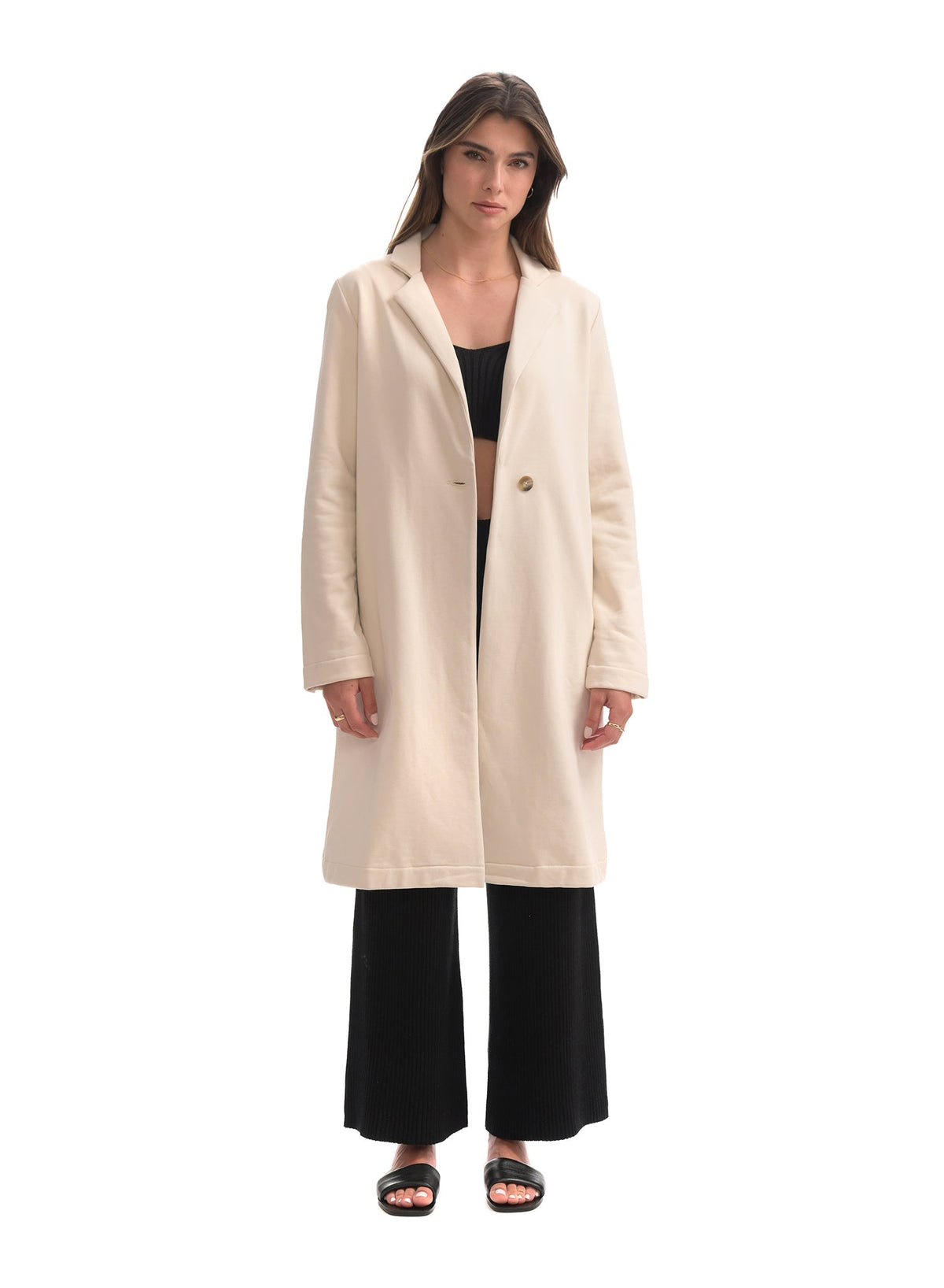 Woman wearing a beige coat on a white background