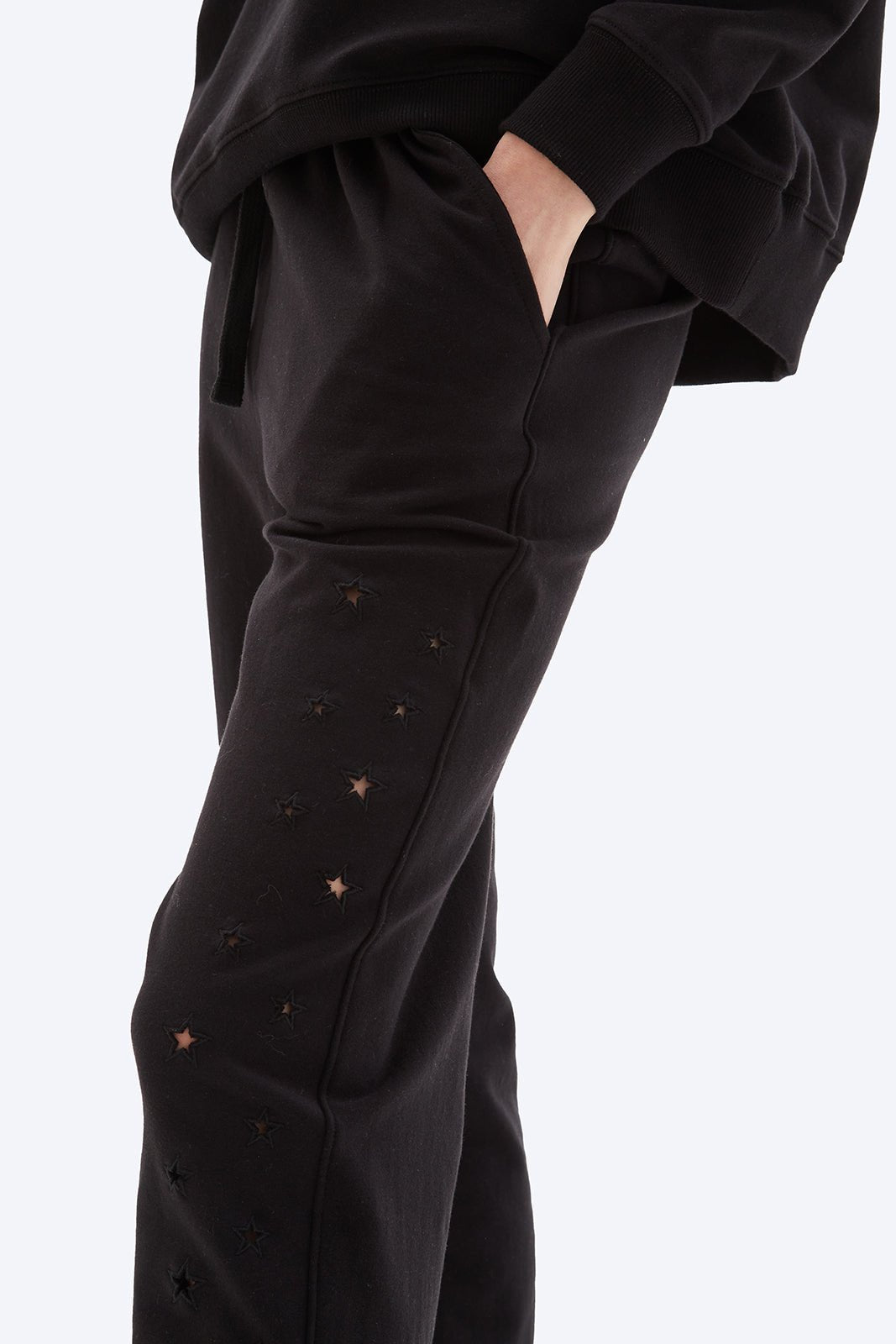 Black pants with star patterns on a white background