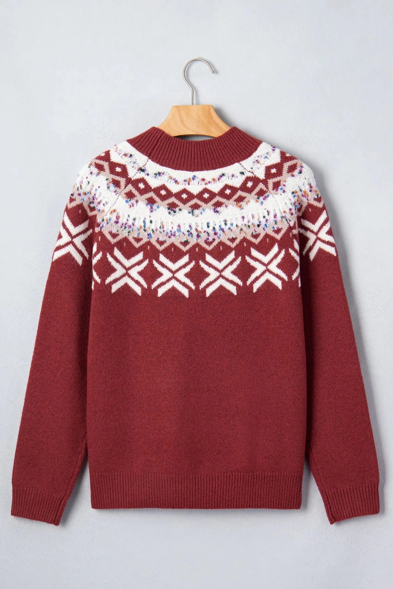 Red knit sweater with a white Fair Isle pattern across the chest and shoulders.