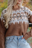 Woman in brown Fair Isle knit sweater with white-black chest pattern and light blue jeans outdoors.