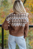 Woman seen from behind in brown Fair Isle sweater with cream-black pattern and light blue jeans.