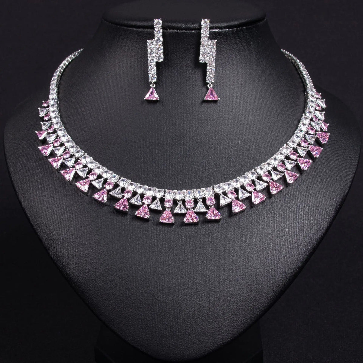 Silver necklace and earrings on a black mannequin