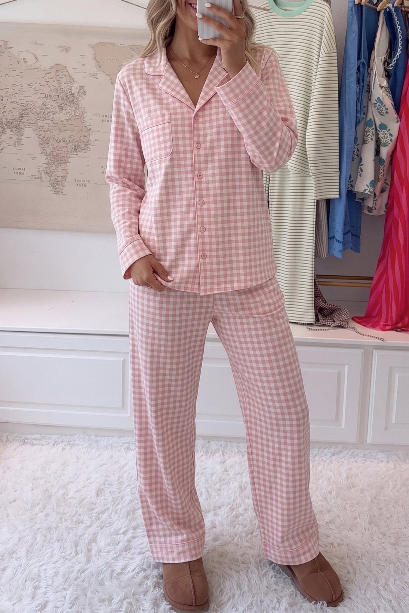 Woman in pink-white gingham pajamas with button-up shirt and wide-leg pants.
