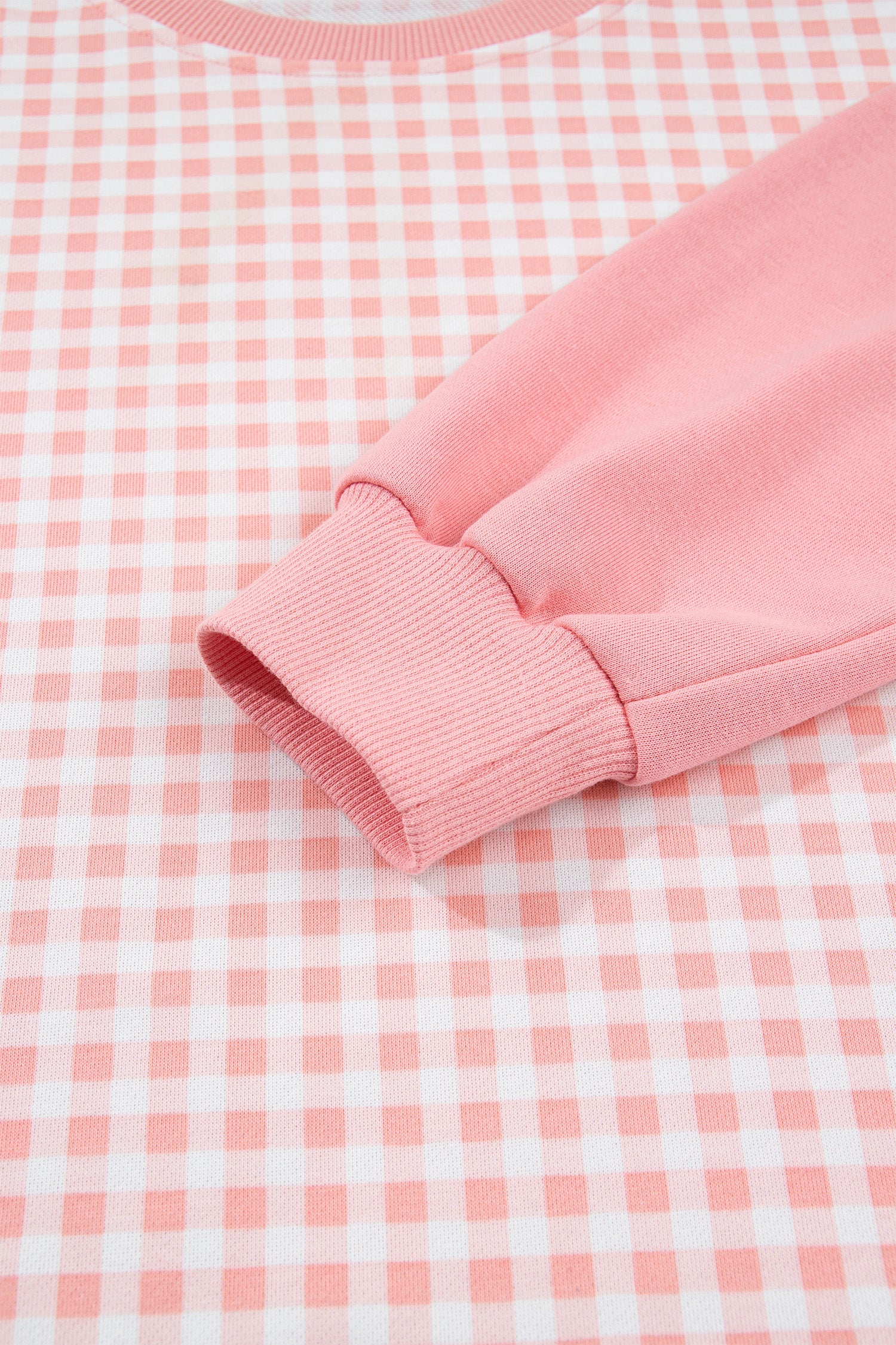 Pink gingham pullover solid ribbed cuff detail