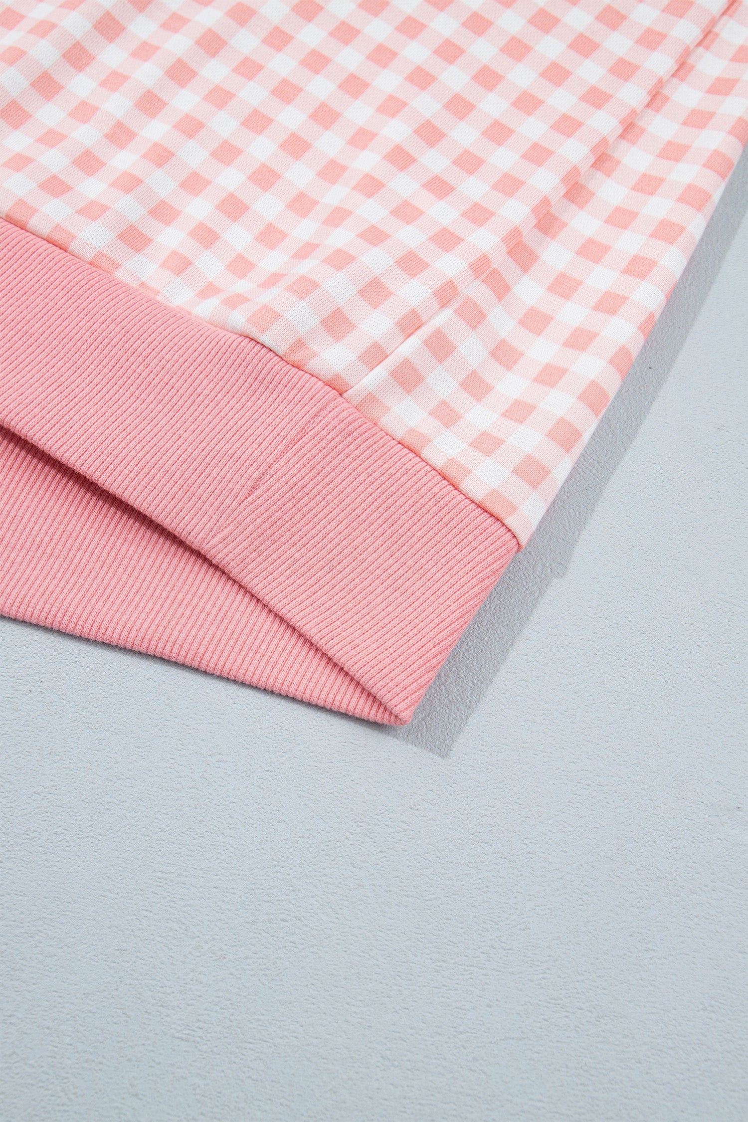 Pink gingham pullover ribbed hem band detail