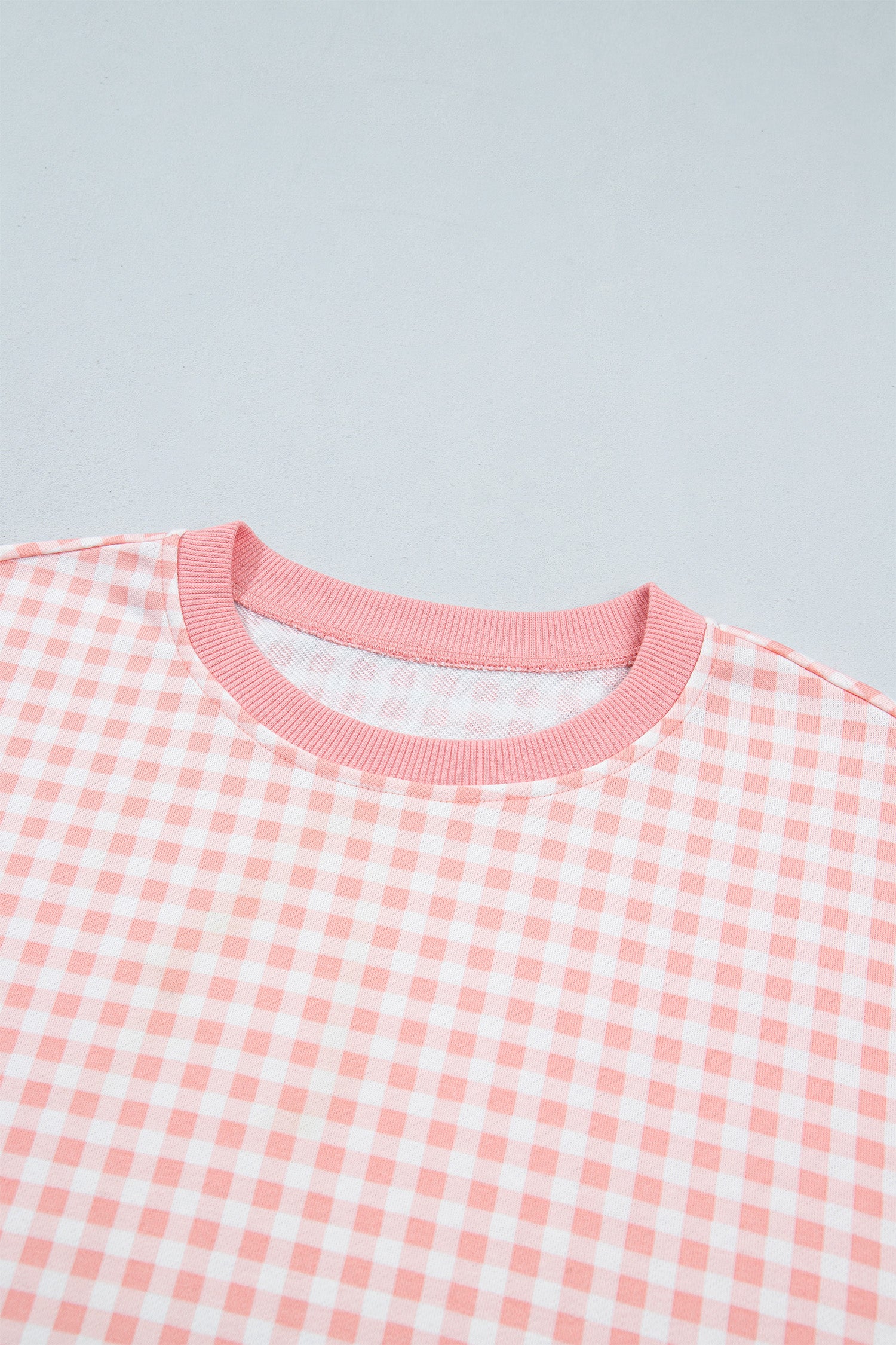 Pink gingham pullover ribbed round neckline detail