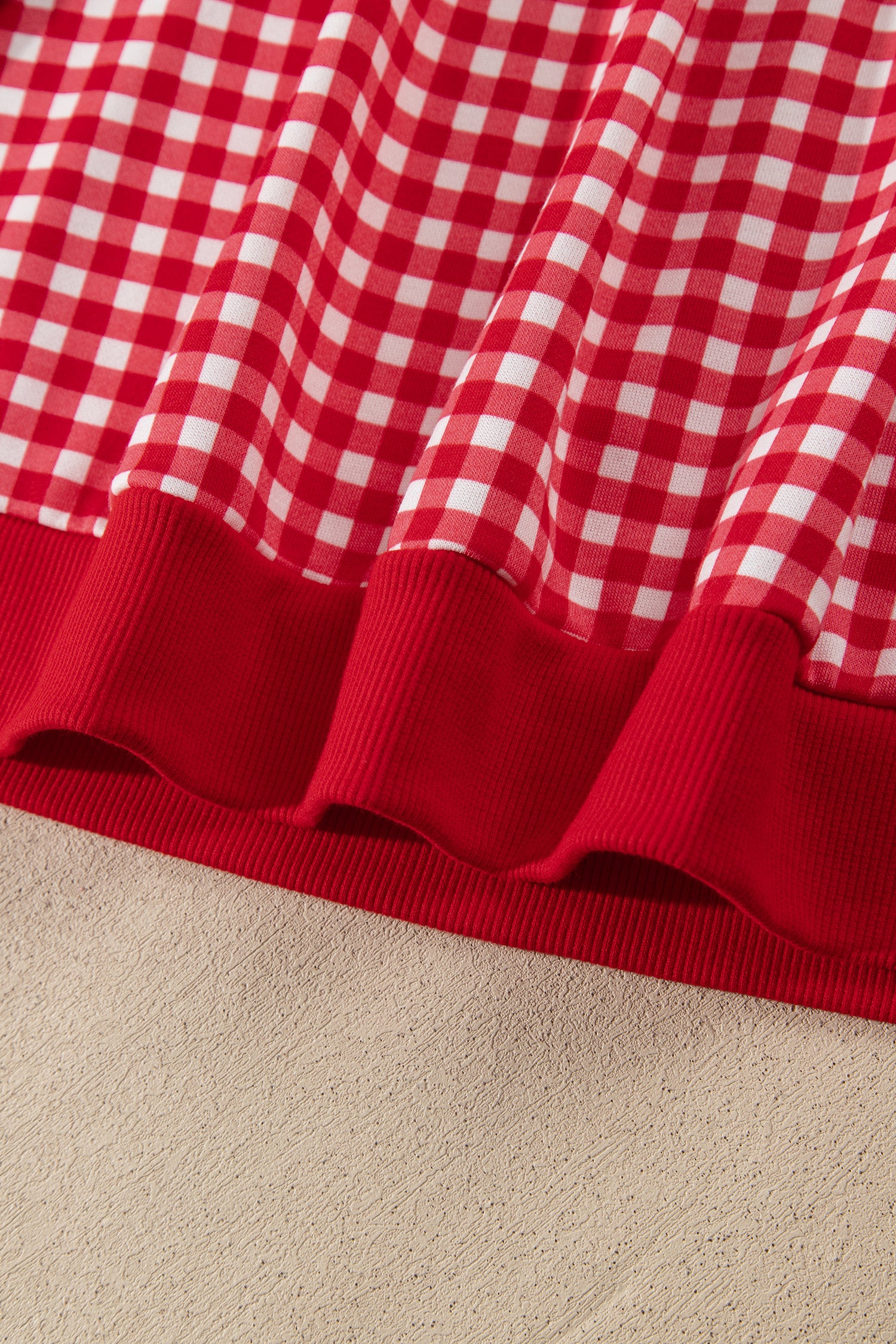Red gingham pullover ribbed hem band detail