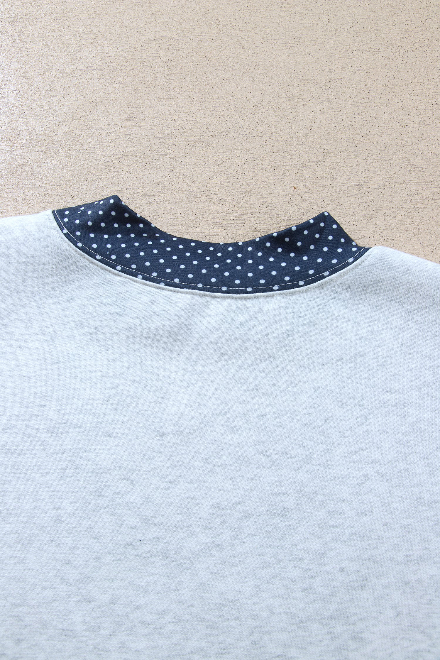 Back neck polka dot trim detail on gray sweatshirt