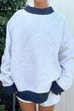 Women's gray sweatshirt with navy polka dot trim at neck, cuffs and hem, front view