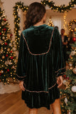 Back view of green velvet shift dress with leopard trimmed yoke and ruffle hem