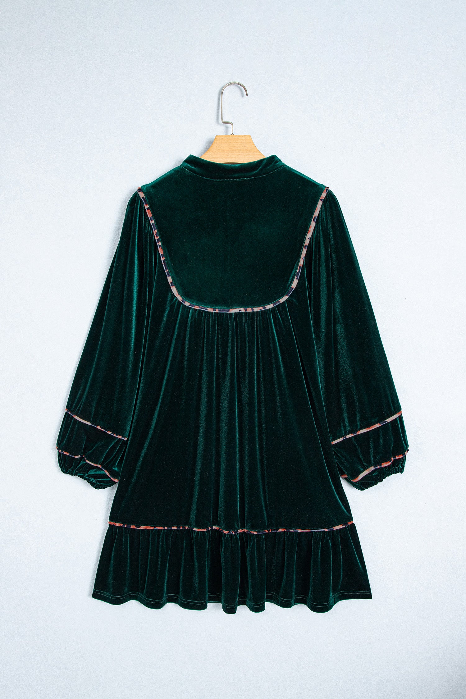 Green velvet leopard trim shift dress on a hanger, back view