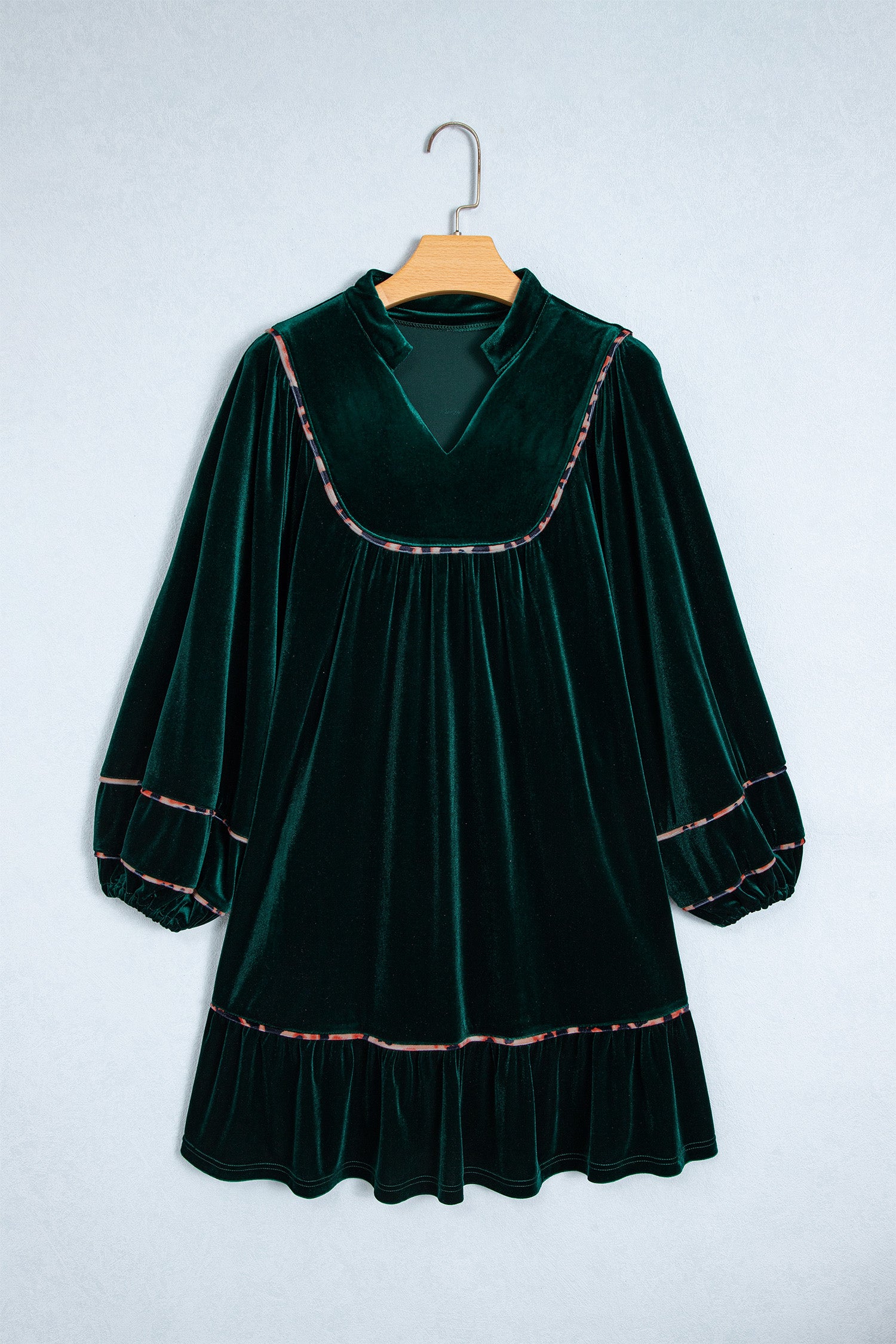 Green velvet leopard trim long sleeve shift dress on a hanger, front view