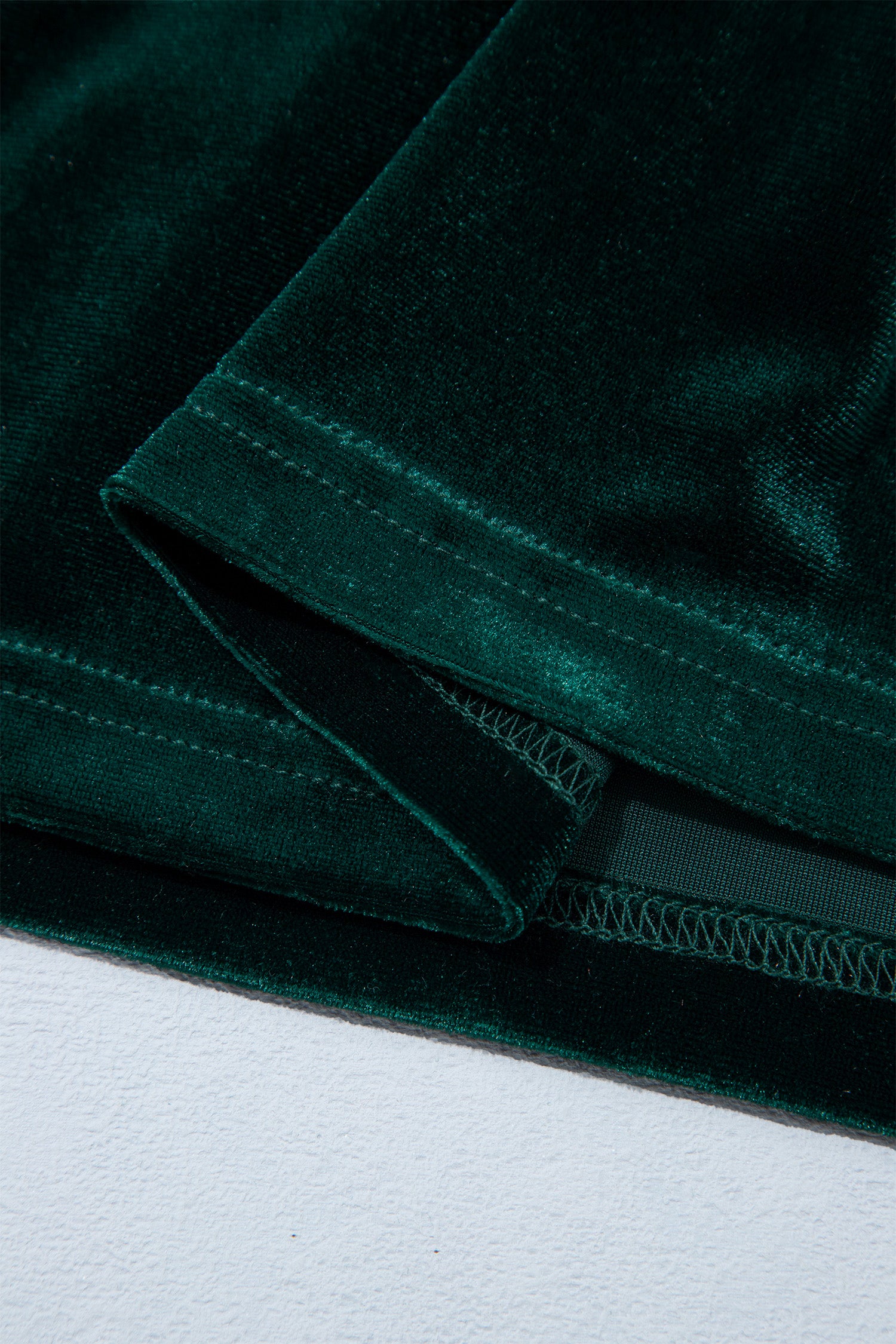Hem detail on blackish green velvet dress