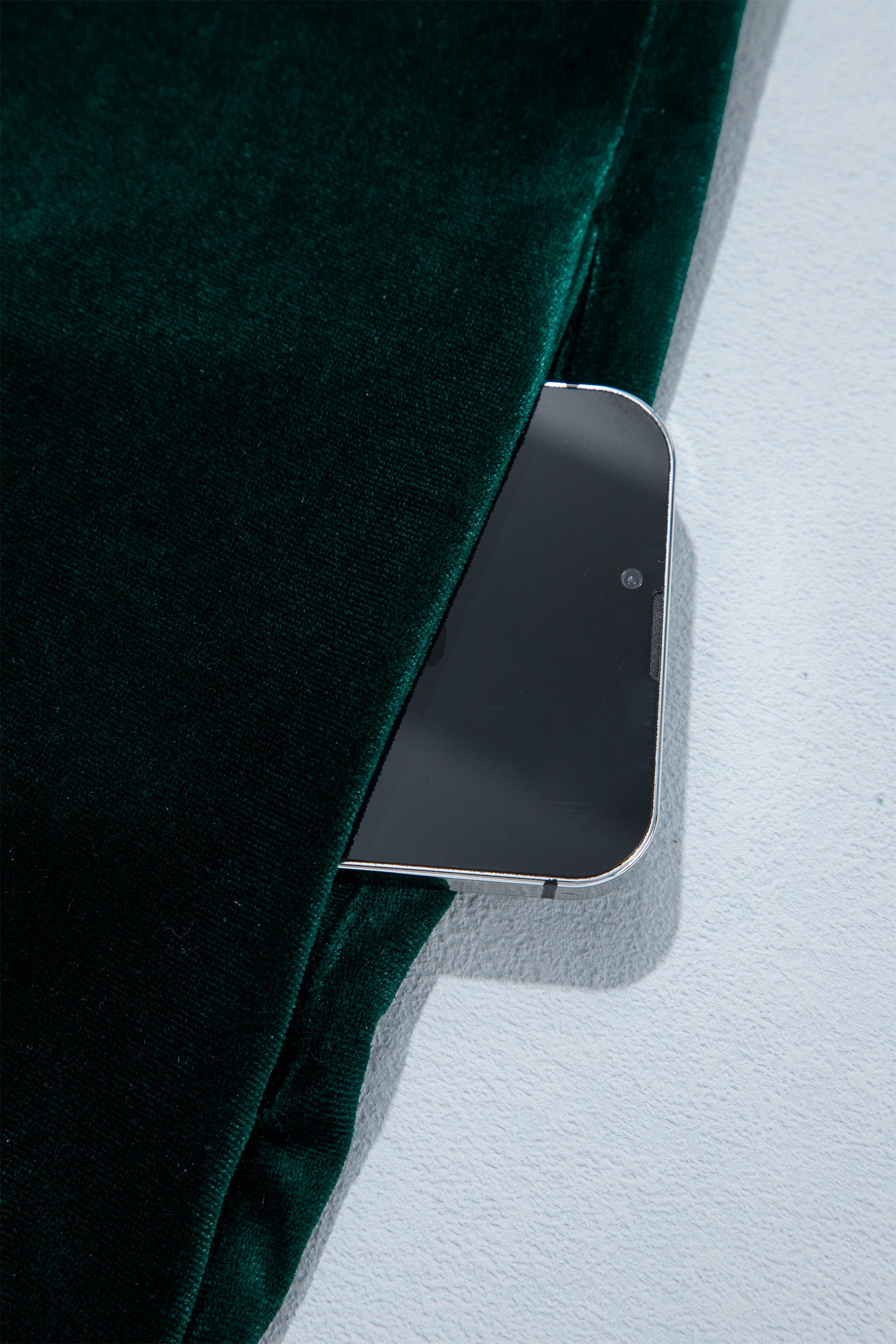 Side seam pocket holding a phone on green velvet shift dress