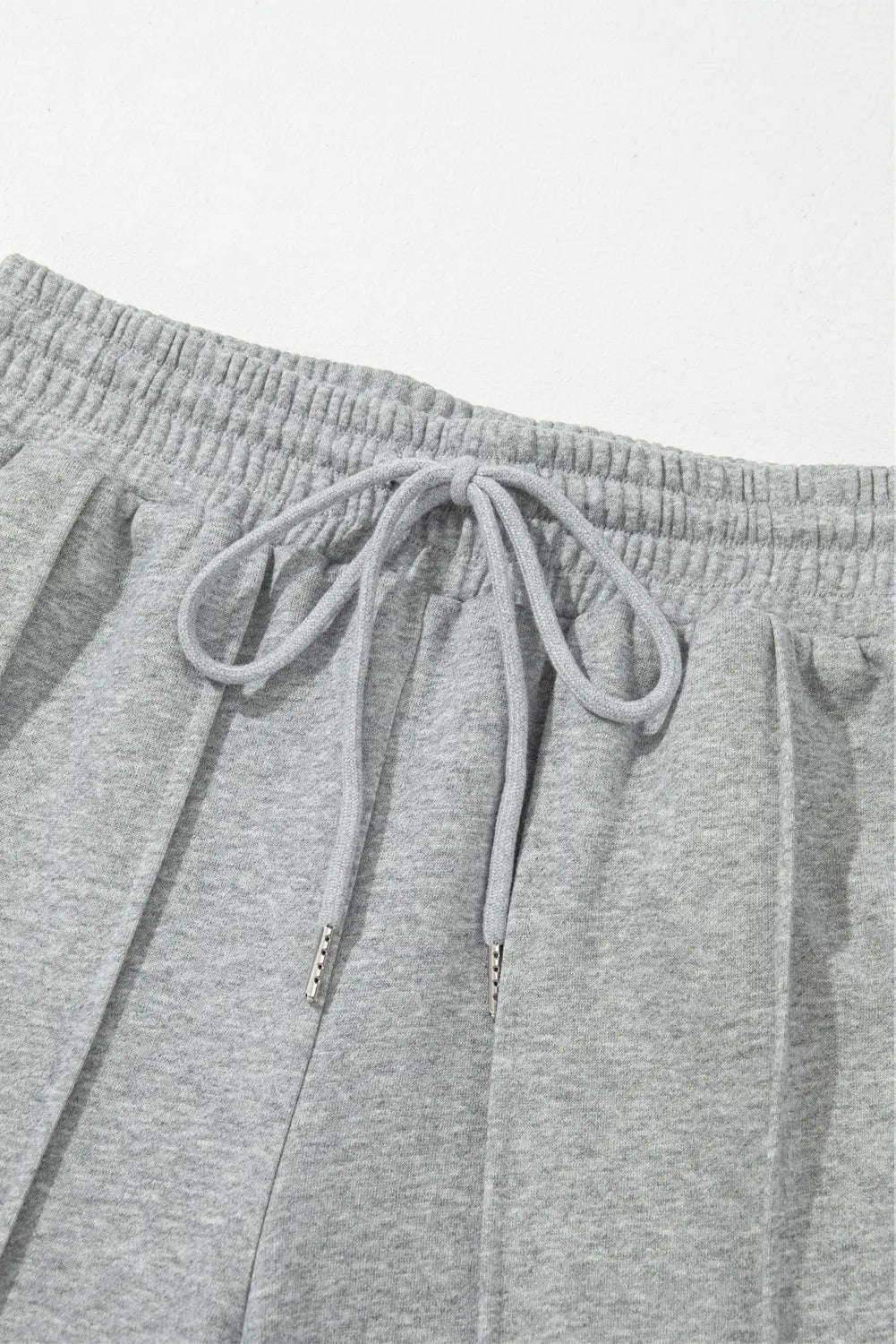 Gray sweatpants with drawstring on a light gray background