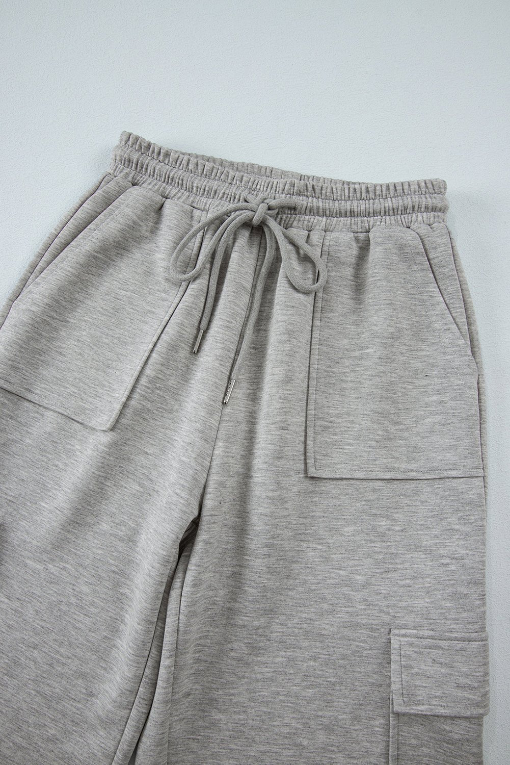 Gray sweatpants with drawstring on a light gray background