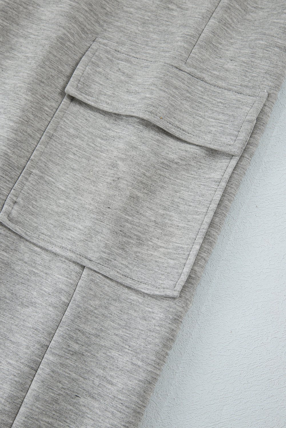 Close-up of a gray textured fabric with pockets