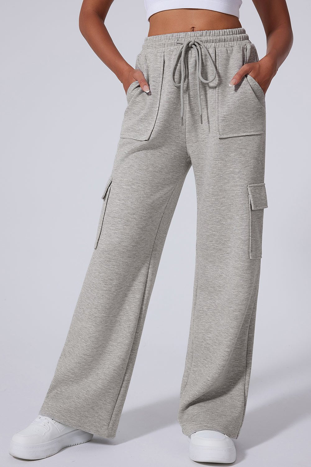 Gray cargo pants worn by a person on a light gray background