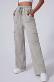 Gray cargo pants worn by a person on a white background