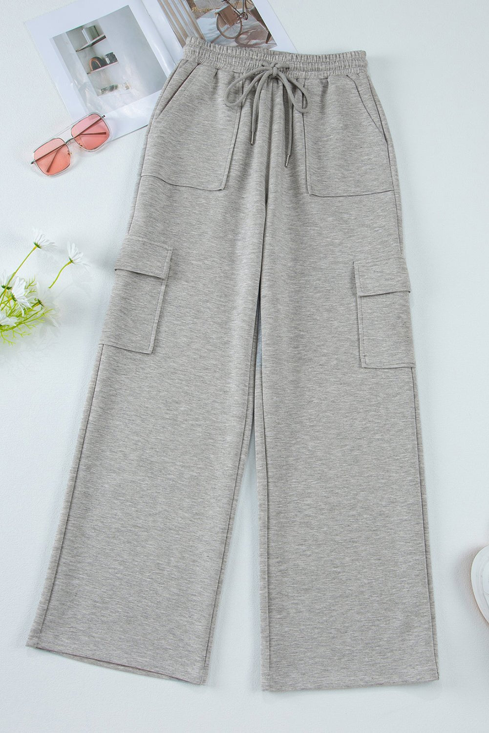 Gray wide-leg pants with pockets on a white background