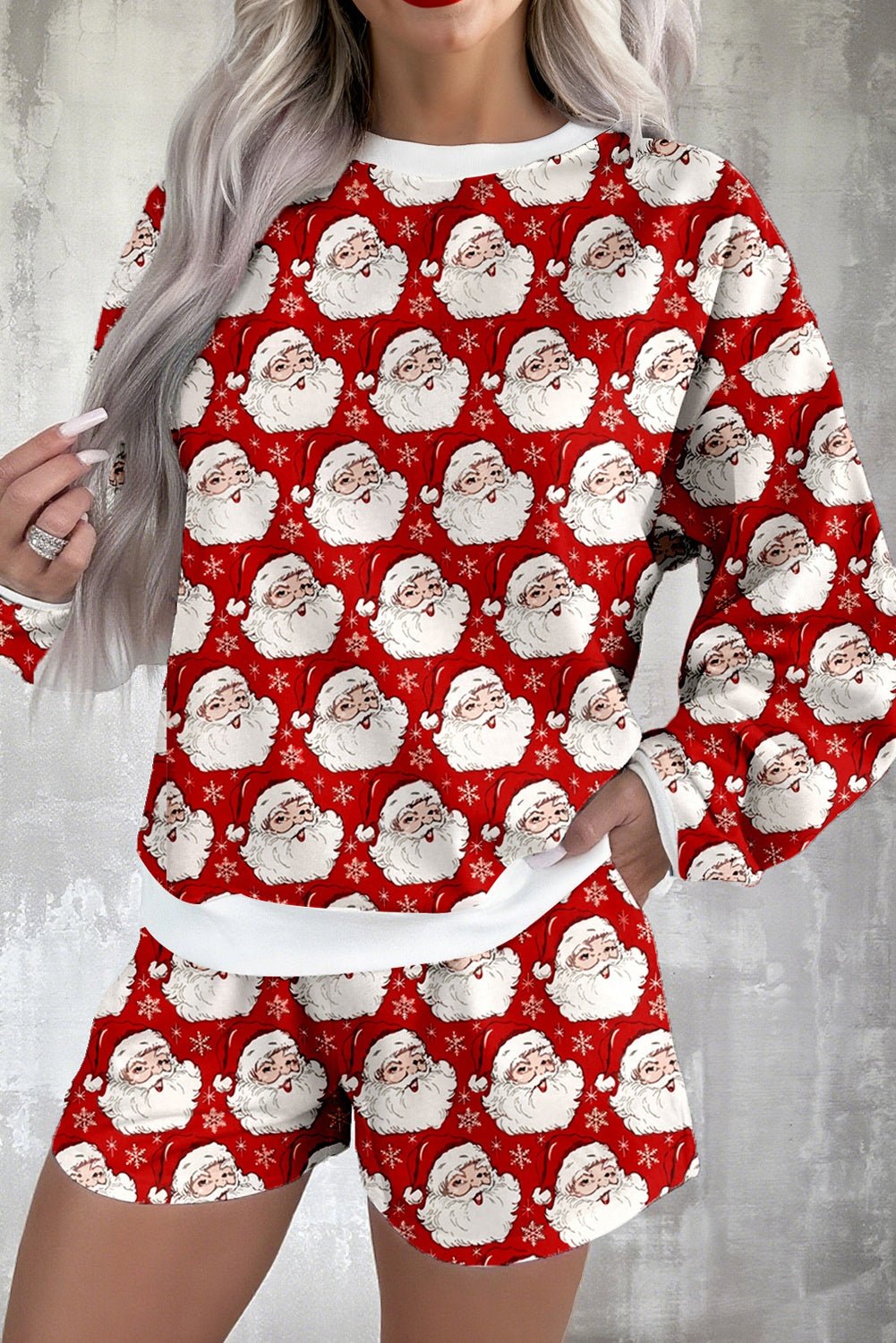 Red pajama set with Santa Claus pattern on a gray background