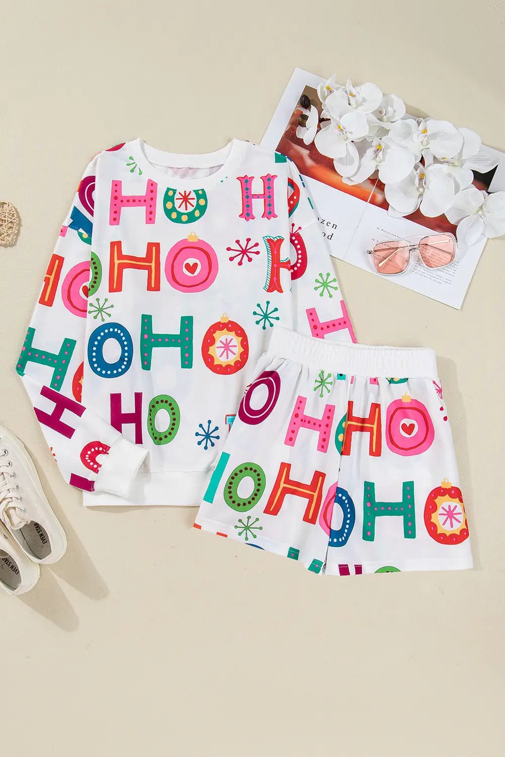 Children's pajama set with 'HO HO HO' print on a beige background