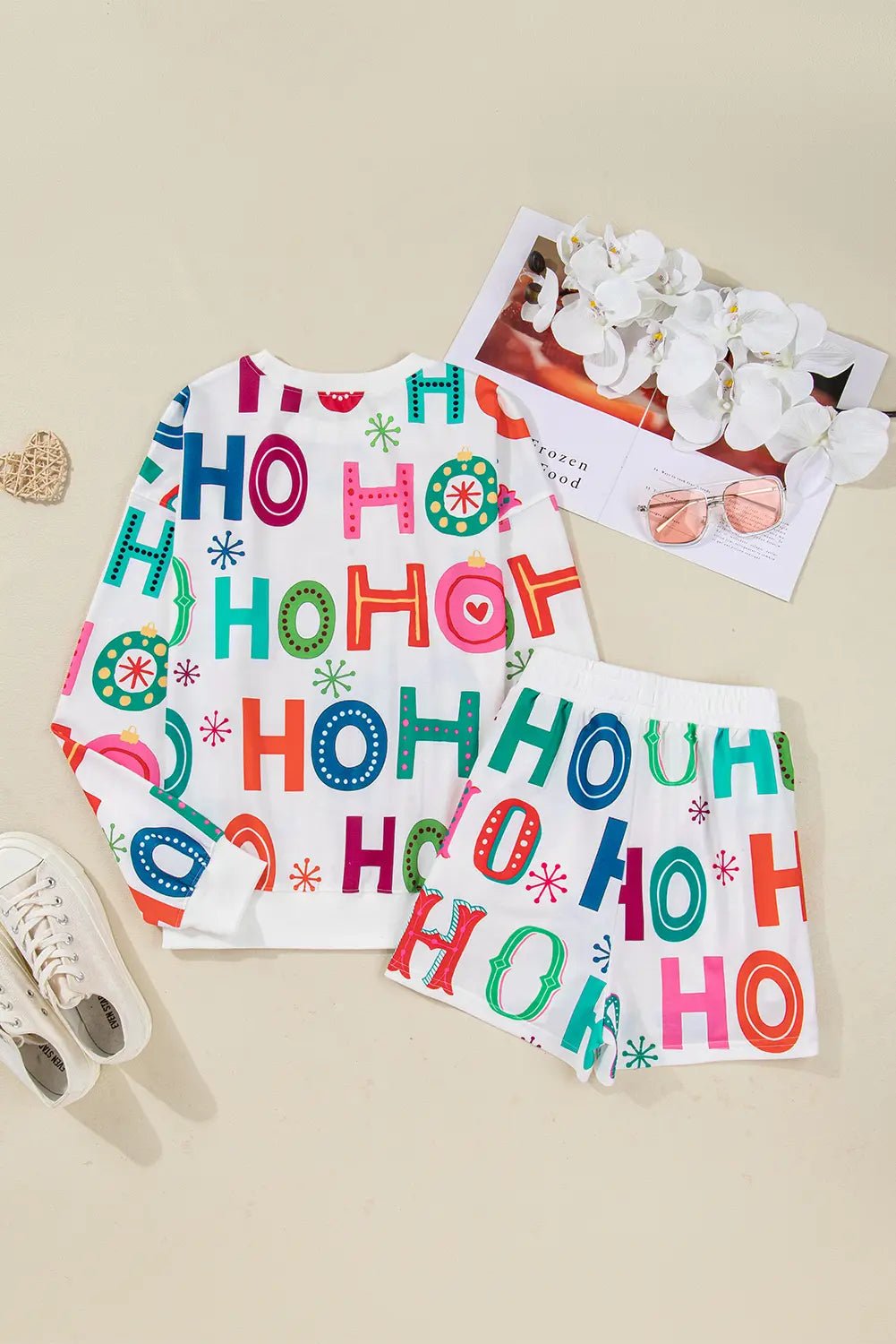Children's pajama set with 'HO HO HO' print on a beige background
