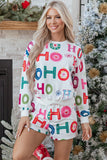 Woman wearing a festive white HO HO HO sweatshirt and shorts set.