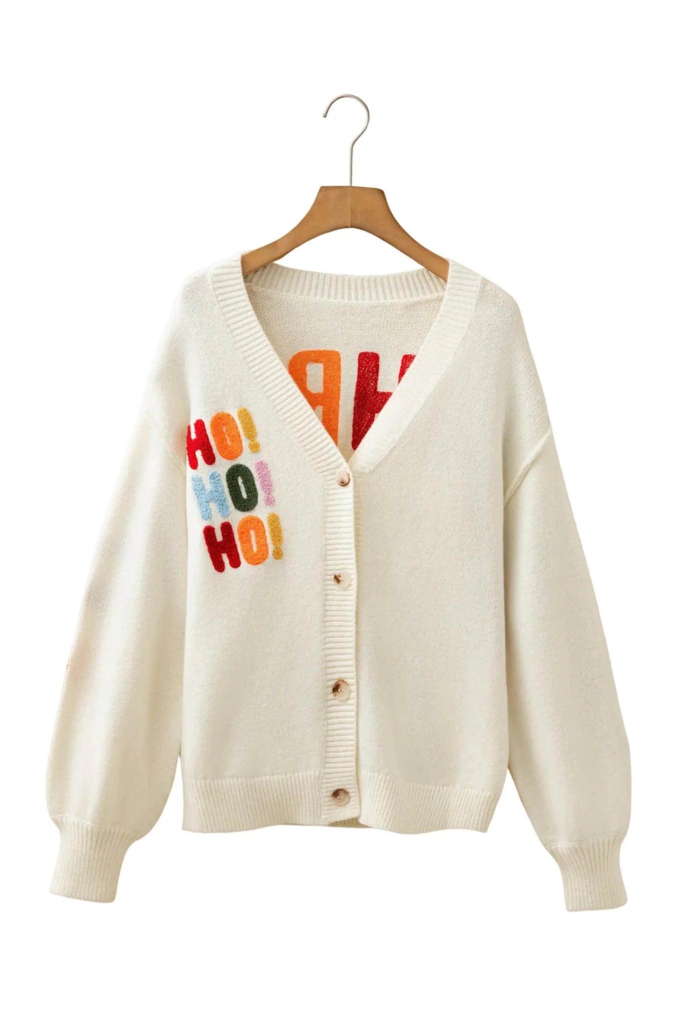 Off-white knit cardigan with colorful “HO! HO! HO!” text on the left chest, hanging on a wooden hanger.