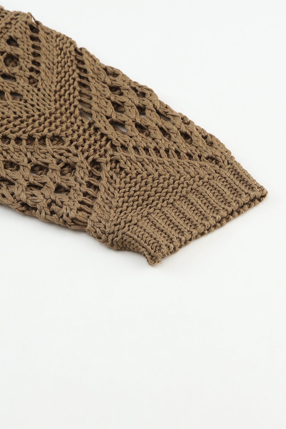 Brown knitted fabric with a textured pattern on a white background