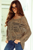 Woman wearing a brown crochet sweater and sunglasses indoors